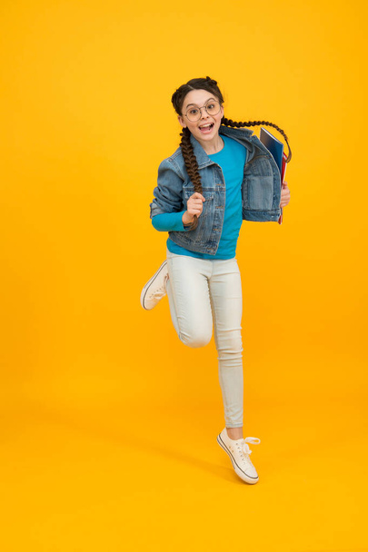 back to school. vision concept. sense of freedom. jumping teenage girl in eyeglasses. kid with braided hair. happy after optometrist. beauty and fashion. eyesight correction of child. happy childhood - Fotografie, Obrázek