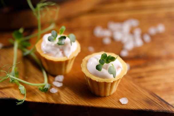 Canapes with light cream filling. Still life with microgreens. The concept of an appetizing snack. Close-up - Φωτογραφία, εικόνα