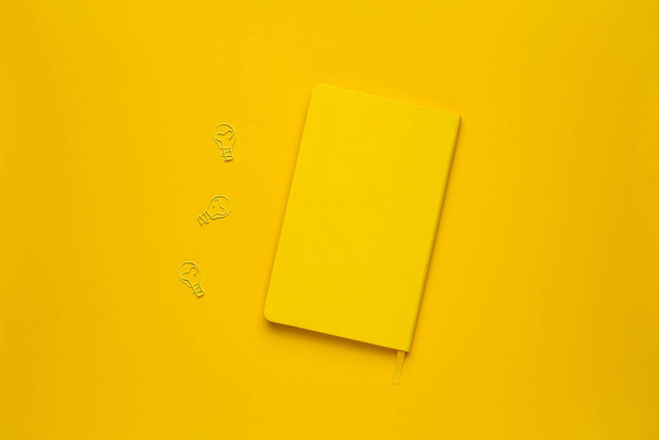 Illuminating pantone colored background with yellow note. Fashionable color of spring-summer 2021 season from fashion week, color of the year 2021 top view - Fotografie, Obrázek