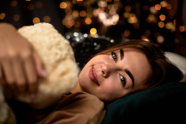 happy young woman is holding teddy bear - Zdjęcie, obraz