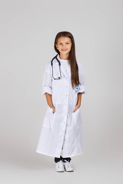 Cute child in doctor coat with stethoscope - Φωτογραφία, εικόνα