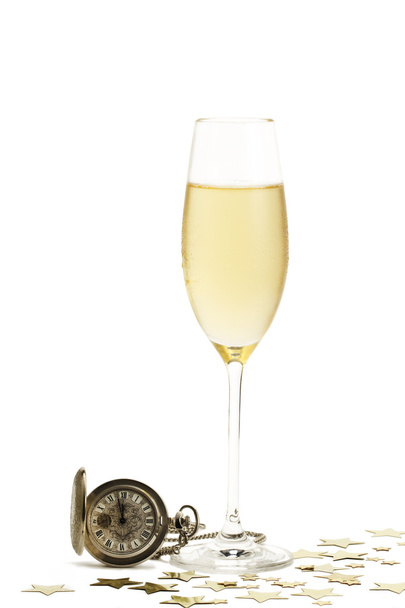 Cold glass of champagne with a old pocket watch and stars - Foto, imagen
