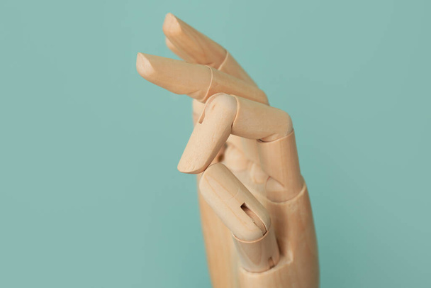 Wooden hand showing OK on color background - Photo, Image