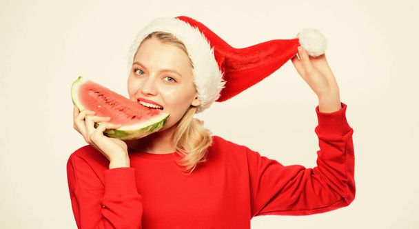 Christmas summer destinations. Woman santa hat hold slice watermelon. Prolong summer. Christmas girl eat watermelon. Travel christmas vacation and holidays resort. Tropical christmas concept - Valokuva, kuva