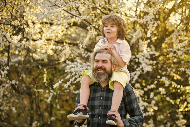 Earth day. Ecology and environment. Simple happiness. Happy family. Fatherhood happiness. Fathers day. Little boy and father in nature background. Hipster and baby son. Happiness concept. Spring walk - Foto, imagen
