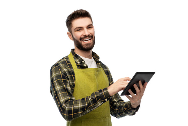 happy male gardener or farmer with tablet pc - Foto, afbeelding