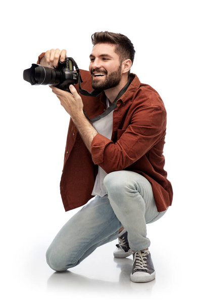 smiling man or photographer with digital camera - Fotó, kép