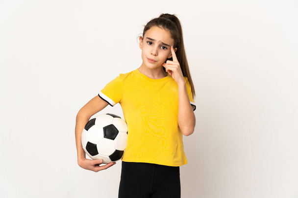 Little football player girl isolated on white background thinking an idea - Foto, Imagem