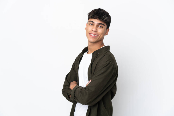 Young man over isolated white background with arms crossed and happy - Fotoğraf, Görsel