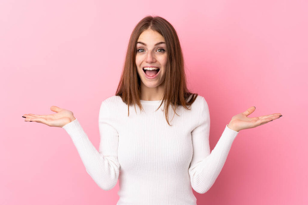 Young woman over isolated pink background with shocked facial expression - Foto, afbeelding