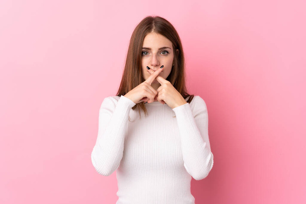 Young woman over isolated pink background showing a sign of silence gesture - Photo, image