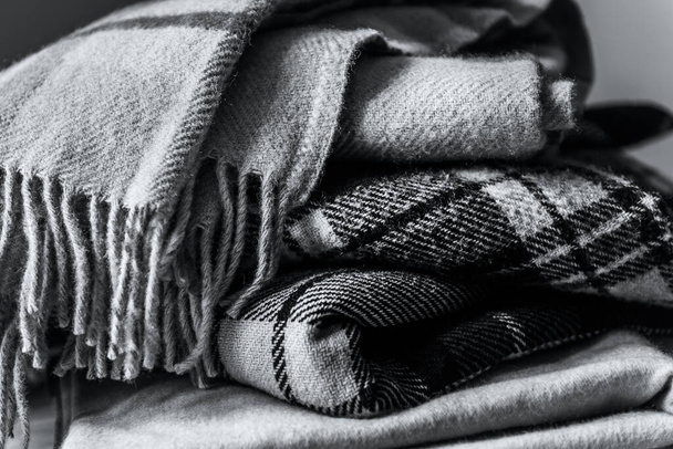 Stack of woolen checked blankets - 写真・画像