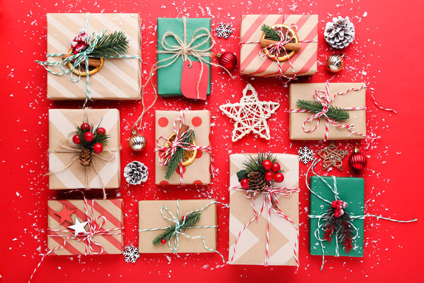Gift boxes with ornaments on red background - Zdjęcie, obraz
