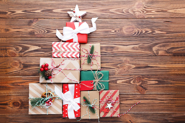 Gift boxes with ornaments on brown wooden background - Foto, imagen