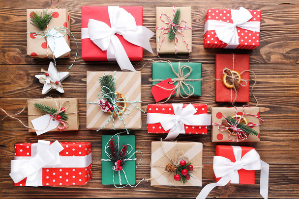 Gift boxes with ornaments on brown wooden background - Φωτογραφία, εικόνα