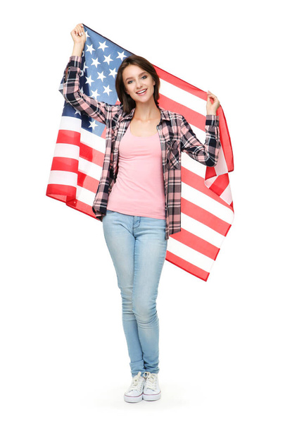Beautiful young woman holding american flag on white background - Φωτογραφία, εικόνα
