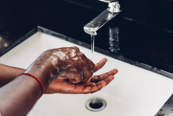 Closeup washing black man hands rubbing with soap and water in sinks to prevent outbreak coronavirus hygiene to stop spreading virus, hygiene for quarantine cleaning COVID-19 concept - Foto, immagini
