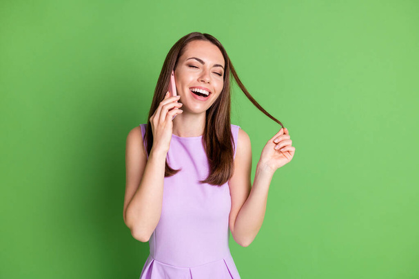 Photo of nice stylish cheerful lady model talk telephone open mouth close eyes chatting speak roaming promote cheap comfy app wear purple dress isolated pastel green color background - Fotografie, Obrázek