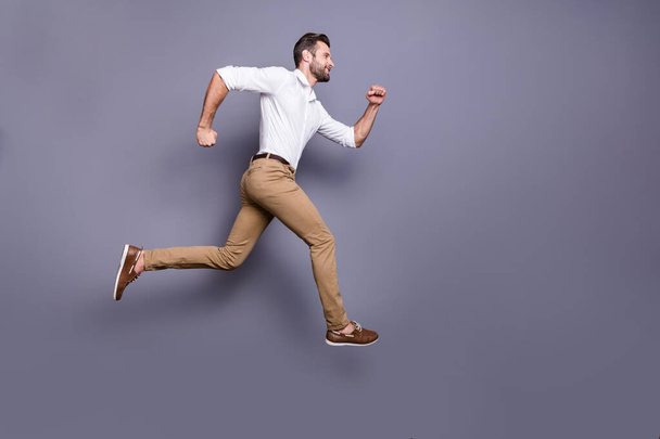 Full length body size view of his he nice attractive content cheerful proud strong motivated energetic man jumping running motivation ambition isolated over grey violet purple pastel color background - Valokuva, kuva