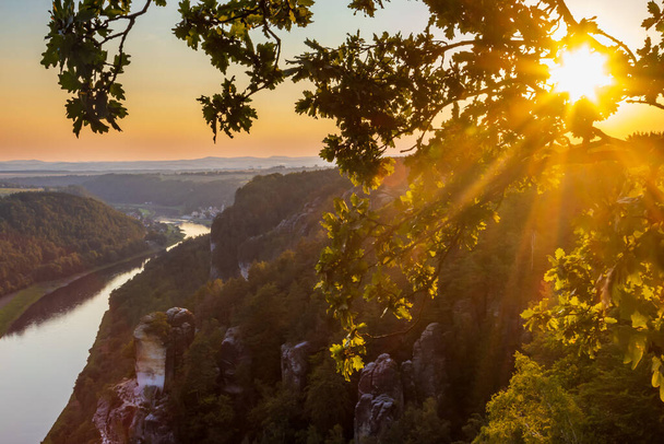 View over the the river Elbe and Saxon Switzerland National Park in the evening light - Foto, afbeelding