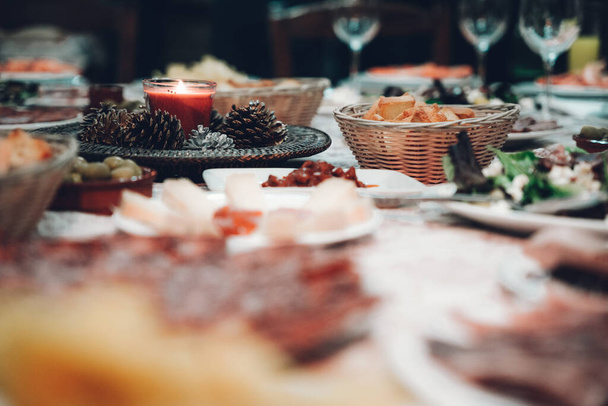 A closeup shot of a delicious dinner table with a variety of appetizers - Photo, image