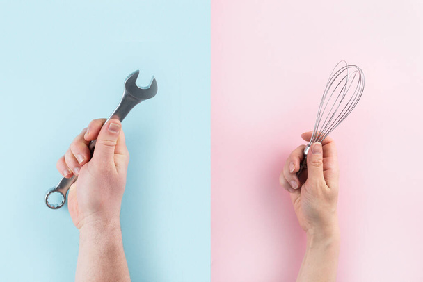 Gender stereotypes concept - female and male hands holding objects on pink and blue background - Fotografie, Obrázek