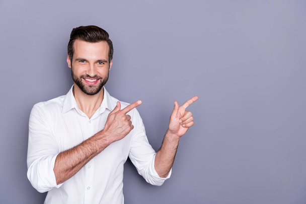 Portrait of positive cheerful man marketer ceo point index finger copyspace recommend suggest select advert promo wear white shirt isolated over gray color background - Photo, image