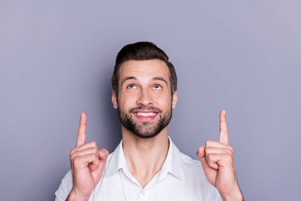 Close-up portrait of his he nice attractive glad cheerful brunet guy employer director expert pointing two forefingers up attention advert ad copy space isolated on gray pastel color background - Photo, image