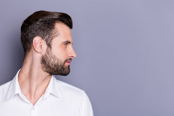 Close-up profile side view portrait of his he nice attractive virile brunet guy groomed unshaven beard copy empty blank place space isolated over gray pastel color background - 写真・画像