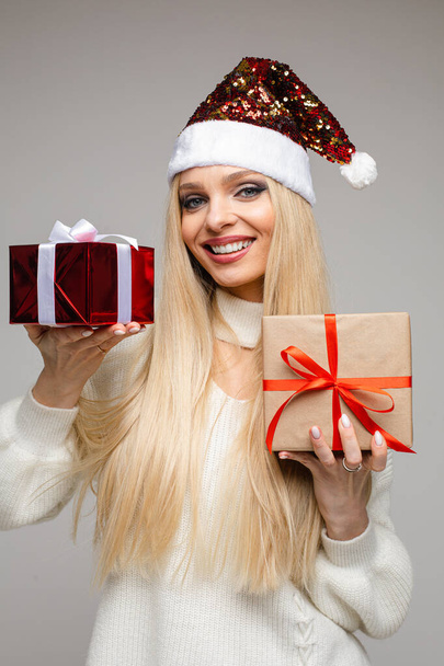 Beautiful blondie with Christmas presents in hands. - Photo, image
