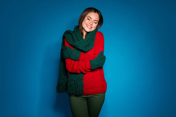 Portrait of her she nice attractive pretty charming dreamy cheerful girl wearing comfortable garment soft wool hugging herself isolated bright vivid shine vibrant blue color background - Fotó, kép