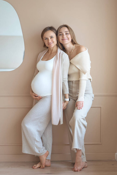 Lesbian couple waiting for baby, woman posing with her pregnant girlfriend - Фото, изображение