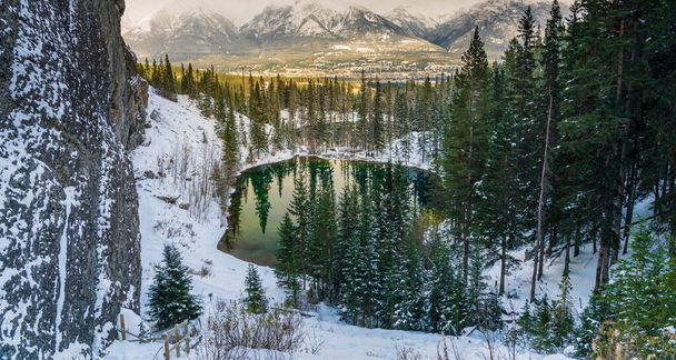 Upper and Lower Grassi Lakes in winter season, Town of Canmore and the Bow River valley in the distance. Alberta, Canada. - Φωτογραφία, εικόνα