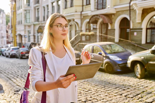 Young business woman in city using digital tablet - Фото, зображення