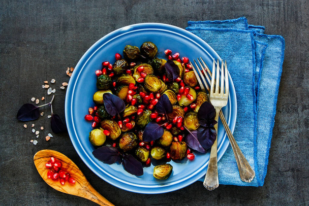 Brussels sprouts salad with basil leaves and pomegranate seeds - Photo, Image