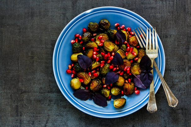 Brussels sprouts salad with basil and pomegranate seeds - Фото, изображение