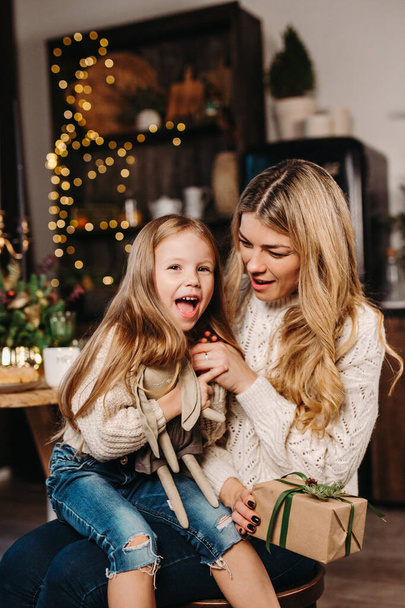 Happy mother and daughter opening presents on Christmas Eve - Fotografie, Obrázek