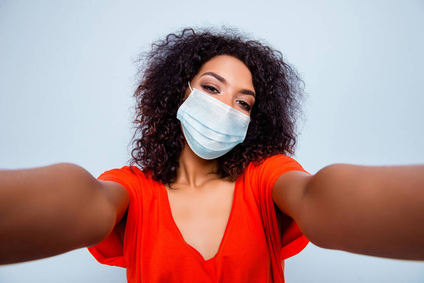Self-portrait of charming wavy-haired girl wearing safety gauze mask flue influenza disease prevention isolated on grey color background - Фото, зображення
