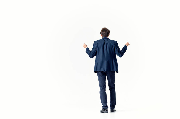business man puzzled look light background suit gesturing with hands finance and work model - Foto, afbeelding