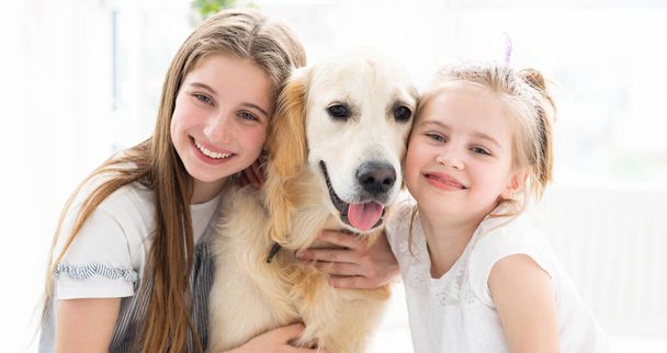 Smiling sisters with cute dog - Valokuva, kuva