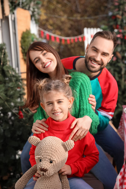 Happy family outdoors on Christmas eve - Photo, Image