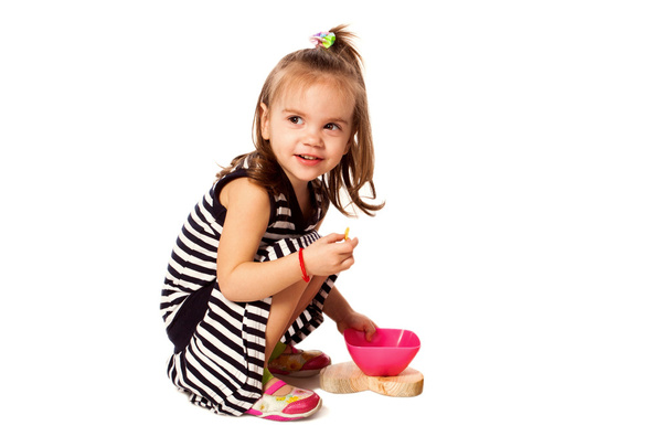 Small girl eat corn flakes isolated on white - Foto, Imagem