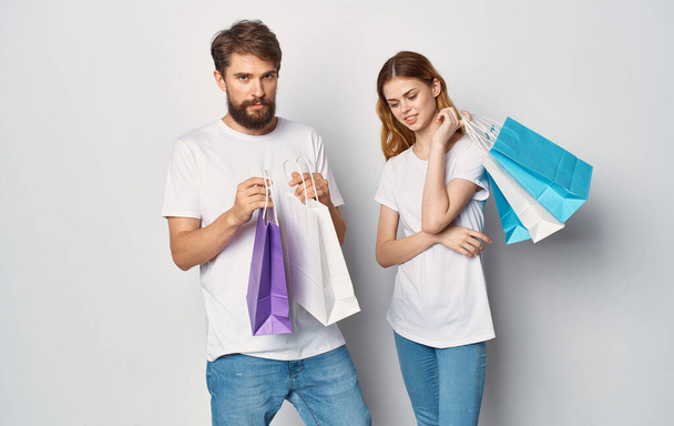 young couple with bags in their hands Shopping fun - Zdjęcie, obraz