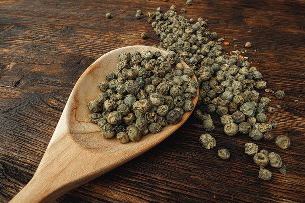 Macro photo of.green peppercorns on table - Photo, image