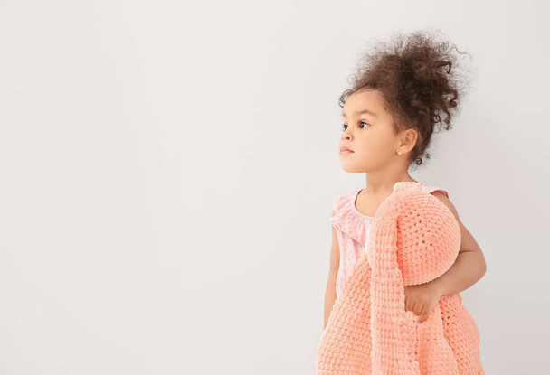 Cute African-American baby girl with toy on white background - Foto, Imagen