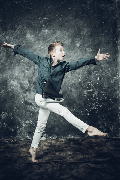 Young figure skater dressed in white jeans and blue shirt - Fotó, kép