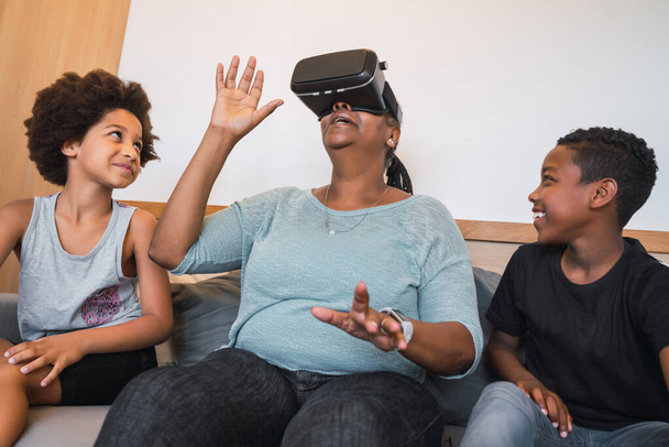 Grandmother and grandchildren playing together with VR glasses. - Fotoğraf, Görsel