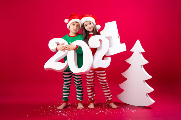 brother and sister in festive costumes holding big 2021 numbers - Φωτογραφία, εικόνα