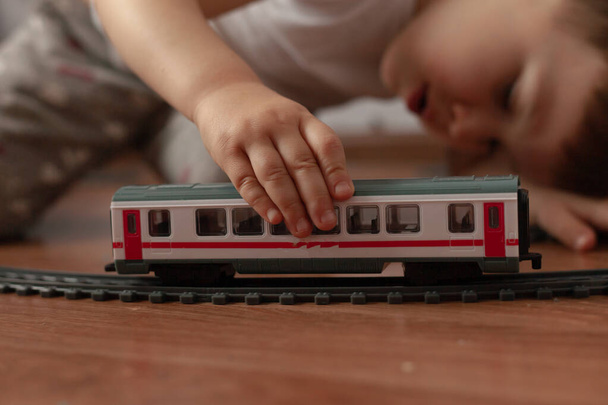 un niño juega con el ferrocarril - Foto, imagen