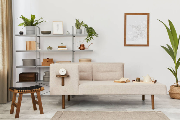 Cozy interior with stylish sofa, grey coffee table, bookcase, plants, carpet, decoration, mock up poster map and elegant personal accessories. Neutral living room in classic house. Template. - 写真・画像